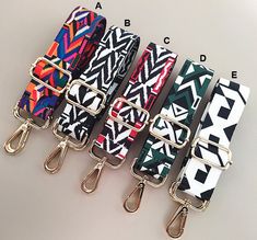 four lanyards with different colors and designs on each one, all tied together