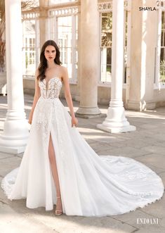 a woman in a white wedding dress posing for the camera