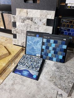 two boxes with blue and black tiles on them