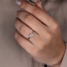 a woman's hand with a diamond ring on it