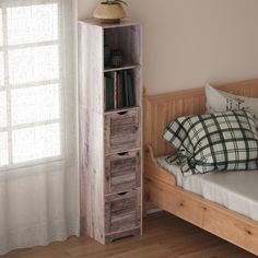 a bed with a wooden bookcase next to a window