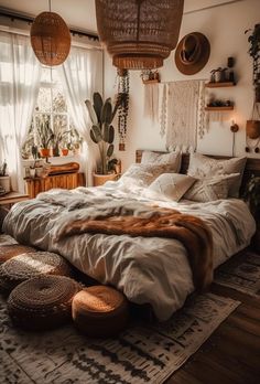 a large bed sitting inside of a bedroom next to a wooden dresser and potted plants