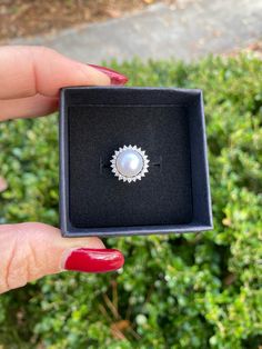 The Pearl is the only gem created in living being. When something penetrates an oyster's shell, it doesn't reject it; it embraces it, encases it & turns it into something beautiful. ♥️ This stunning ring features a freshwater pearl encircled by lustrous crystals. Available in silver or gold. Adjustable, size 5-8 PRODUCT DETAILS: 10mm AAA freshwater button iridescent pearl Luster - High Setting: sterling silver or 14kt gold plated with crystal mount Size: Adjustable, Size 5-8 Materials: Freshwate Fine Jewelry Pearl Promise Ring With Halo Setting, Silver Akoya Pearl Drop Ring, Round Pearl Ring With Halo For Anniversary, Anniversary Round Pearl Ring With Halo, Silver Ring With Pearl Charm, Silver Akoya Pearl Ring With Pearl Drop, Gift Akoya Pearl Jewelry In Round Cut, Fine Jewelry Pearl Drop Ring, Fine Jewelry Pearl Ring For Promise