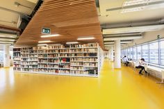 an empty library with yellow floors and bookshelves