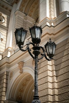 an old fashioned street light in front of a building