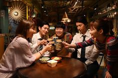 a group of people sitting around a table eating food