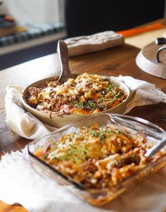 two casserole dishes on a table with napkins