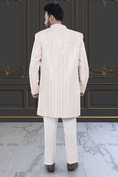 This Mens Sherwani (M42-S133) is an open jacket style with exquisite sequin and thread embroidery. The intricate detailing adds a touch of elegance to this traditional attire. Perfect for weddings and special occasions, this sherwani is a must-have for anyone looking to make a statement. Festive Long Sleeve Sherwani With Mirror Work, Bollywood Style Festive Sherwani With Sequins, Diwali Sequin Sherwani Unstitched, Diwali Unstitched Sequined Sherwani, Festive Sherwani With Sequins For Festivals, Unstitched Sequined Sherwani For Diwali, Diwali Sequins Bandhgala With Long Sleeves, Festive Diwali Sherwani With Sequins, Traditional Long Sleeve Sherwani With Sequins