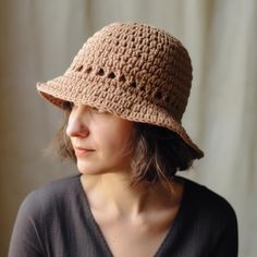 a woman wearing a brown crochet hat