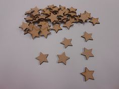 several wooden stars are arranged on a white surface