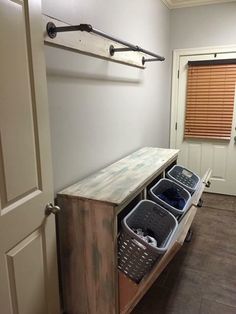 an entryway with storage baskets on the floor