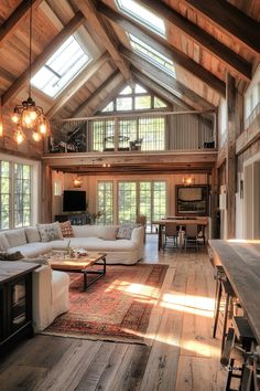 Spacious living area with rustic industrial house design, featuring wooden beams, tall ceilings, cozy seating, and ample natural light from large windows. Rustic Small House Ideas, Build Your Own House On A Budget, How To Build A House Cheap, Build Cheap House, Small Home Building Ideas, Barndominium Ideas Simple, Build A House On A Budget, Building A House Aesthetic, Small Barn Conversion Interiors