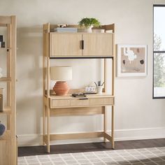 a wooden shelf with a lamp and other items on it in a living room area