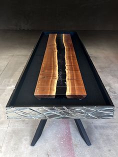 a table made out of wood and metal with an interesting design on the top,