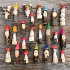 a group of small wooden gnomes sitting on top of a wooden table next to each other