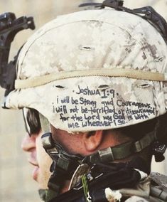 a close up of a man wearing a helmet with writing on it