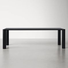 a black table sitting on top of a white floor