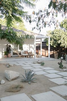 an outdoor patio area with rocks and plants