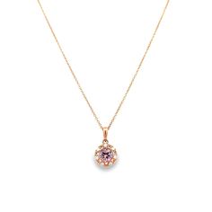 This elegant drop pendant is exquisitely crafted from 14 karat rose gold, showcasing a .80 carat Lotus Garnet at its center, beautifully encircled by .10 carats of diamond accents. The Lotus Garnet, a rare gemstone discovered in late 2015 in the Mahenge region of northern Tanzania, is prized for its unique color palette, ranging from pink to orange hues. This distinct range of colors is the result of a blend of Pyrope, Almandine, and Spessartine garnet compounds found within the stone, offering Elegant Jewelry With Rose Cut Round Diamonds, Fine Jewelry In Pink Gold With Halo Setting, Luxury 14k Rose Gold Jewelry With Halo Setting, Rose Gold Teardrop Pendant Diamond Necklace, Delicate Rose Gold Jewelry With Halo Setting, Rose Gold Teardrop Diamond Necklace, Elegant Rose Gold Diamond Necklace With Flower Pendant, Elegant Pink Gold Jewelry With Rose Cut Diamonds, Rose Gold Round Cut Diamond Necklace For Formal Occasions