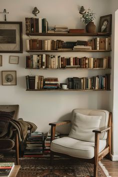 a living room filled with furniture and lots of books on the shelf above it's head