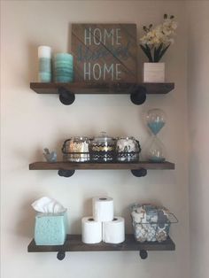 two shelves with toilet paper and other items on them