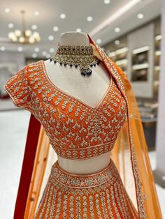 Bridal Lehenga BL-004 is a stunning lehenga for brides. It is adorned with intricate details and made from quality fabric for a luxurious feel. The lehenga is stylish and comfortable, perfect for a memorable wedding day. Fabric: Raw Silk WASH CARE INSTRUCTIONS - Please Dry clean only when it is applicable Ready to Ship! Orange Indian Lehenga, Unstitched Wedding Lehenga With Tilla Embroidery, Wedding Lehenga Unstitched With Tilla, Unstitched Tilla Lehenga For Wedding, Designer Bollywood Choli With Tilla Detailing, Elegant Designer Tilla Sharara, Bollywood Style Designer Choli With Tilla, Festive Unstitched Tilla Lehenga, Designer Semi-stitched Tilla Choli