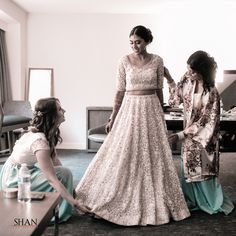 two women standing next to each other in a room