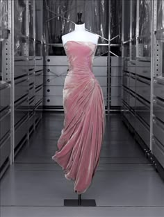 Maison Grès, Paris, France | Pleated 'bustier-style' evening dress, | Madame Grès, Autumn-Winter 1956-1957 | The large quantities of fabric used for the skirt are held in place solely by chevron pleats on the hip that drape downwards to form broad pointed pleats on the side | Shot silk velvet with glints of beige and wild rose by L. Bodin | Musée de la mode de la Ville de Paris Madame Gres, Vintage Gowns, Moda Vintage, Cebu, 1950s Fashion, Gorgeous Gowns