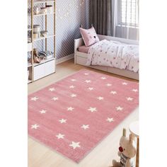 a pink rug with white stars on it in a child's playroom area