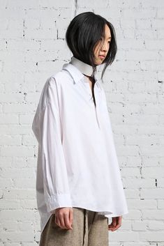 Color: White Classic drop neck shirt Front pocket/ button up Oversized - Order size down Model is 5’11” and wearing size M Bust 34”; waist 24”; hips 35” Machine wash cold, Do not tumble dry 100% Cotton Imported R13W7469-001 White Collared Top With Placket, White Collared Blouse With Placket, White Blouse With Collared Neckline And Placket, Oversized White Blouse With Placket, White Blouse With Shirttail Hem And Placket, White Shirt With Placket, White Collared Shirt With Placket, White Relaxed Fit Blouse With Collared Neckline, White Relaxed Fit Blouse With Placket