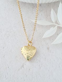 Tiny gold heart locket necklace. Photos can be added either side by slipping them under the rim of the locket. Simple and minimalist. The locket is 12mm in diameter. Silver plated locket is also available in this shop - see picture. I do not fit photos as I do not have the facilities to do do. Necklaces, bracelets and anklets where possible will arrive on a necklace card and placed inside an organza bag ready for giving - see last picture. This item ships from the UK within 1 working day. Gold Heart Necklace With Adjustable Chain For Wedding, Delicate Locket Necklace For Valentine's Day, Dainty Locket Necklace With Adjustable Chain For Wedding, Dainty Gold Locket Necklace With Charms, Dainty Gold-plated Heart Necklace For Weddings, Delicate Gold Locket Necklace For Wedding, Dainty Wedding Locket Necklace With Adjustable Chain, Dainty Gold Plated Heart Necklace For Wedding, Gold Plated Heart Necklace With Delicate Chain For Wedding