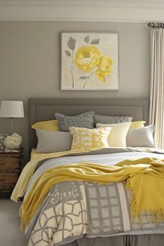 a bed with yellow and gray decor in a bedroom