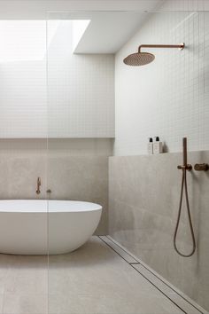 A luxurious bathroom features a walk in shower and freestanding bath with brushed copper tapware. Bathroom Interior Design Modern Master Bath, Abi Interiors, Modern Master Bath, Bathroom Interior Design Modern, Small Bathroom Interior, Small Bathtub, Back To Wall Bath, Brushed Copper, New Bathroom