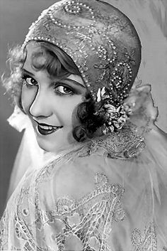 an old photo of a woman wearing a veil