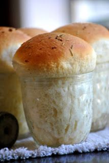 three rolls sitting on top of a table next to a jar