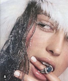 a woman with white and black nail polish on her nails is posing for the camera