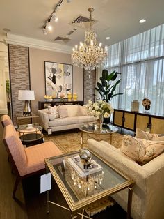 a living room filled with furniture and a chandelier