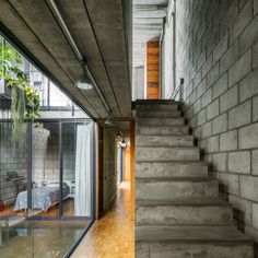 the stairs lead up to the bedroom in this modern house with concrete walls and flooring