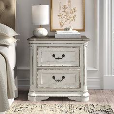 a white nightstand with two drawers in a bedroom