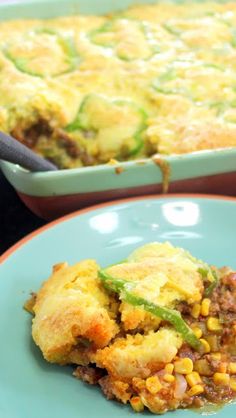 a casserole dish with meat and vegetables in it is on a blue plate