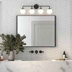 a bathroom vanity with marble counter top and white tile walls, along with three lights above the mirror