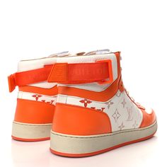 These are authentic LOUIS VUITTON Calfskin Monogram Rivoli High Top Sneakers Size 9 in Orange. These luxurious high tops are crafted of orange and white monogram calfskin leather. The shoe also features straps at the ankles. Authentic Louis Vuitton, High Top, Top Sneakers, High Top Sneakers, High Tops, Calf Skin, Louis Vuitton, Monogram, Orange