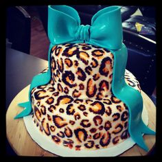 a leopard print cake with a blue bow on top