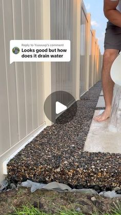 a man is washing his feet with a bucket and water hose on the side of a building