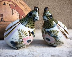 two ceramic birds sitting next to each other