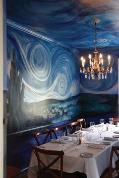 the dining room is decorated with an artistic mural