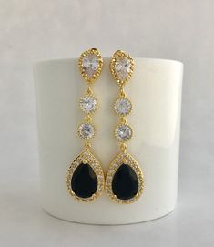 I've created these absolutely gorgeous super sparkly long black crystal earrings in gold plated brass setting. Earrings feature a large teardrop with pear cut black cubic zirconia center surrounded by tiny round zirconia crystals. Teardrop dangles from a bright cubic zirconia ear stud and two round cubic zirconia connectors. Total length of the earrings is 6 cms. For matching necklace click: https://www.etsy.com/listing/763689760/black-bridal-necklace-black-gold-crystal?ref=shop_home_active_2 Fo Glamorous Black Crystal Earrings For Wedding, Black Cubic Zirconia Earrings For Evening, Black Drop Crystal Earrings, Black Crystal Earrings For Wedding, Black Crystal Drop Earrings, Black Crystal Earrings As Gift, Elegant Black Drop Bridal Earrings, Black Wedding Jewelry, Black Gold Earrings