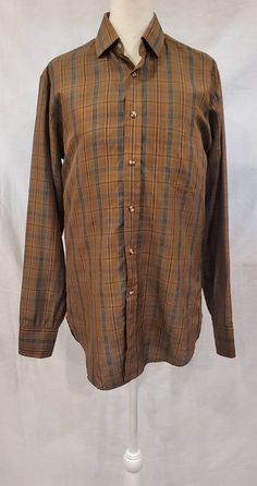 "A nice simple plaid men's silk dress shirt - perfect for dressing up or down. -1960s / 1970s -Private Stock -Fabric - Silk -Buttons up the front / High neck button -Long Sleeve with button cuff ( one button ) -Left side open pocket -This is in good condition except the neckline that has a few fabric scratches ( see pictures ) Measurements: Chest: 40\" Sleeve length from shoulders to wrist: 25\" Shoulders seam to seam: 16\" Length from shoulders to hem: 29\"" Classic Plaid Shirt For Daywear, Brown Shirt With Buttons For Daywear, Formal Plaid Shirt For Fall, Vintage Long Sleeve Business Shirt, Vintage Fitted Business Shirt, Classic Fitted Collared Flannel Shirt, Vintage Plaid Shirt For Work, Fitted Plaid Flannel Shirt With Spread Collar, Brown Buttoned Shirt For Daywear