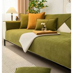 a living room with green couches and pillows