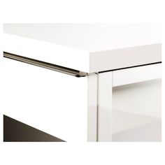 a close up view of the drawer on a white kitchen cabinet with stainless steel handles